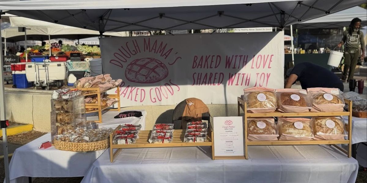 The Dough Mama’s tent at the West Palm Beach GreenMarket with the Baked With Love, Shared With Joy banner