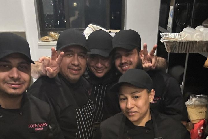Chef Taisha’s New York kitchen crew in black caps and chef jackets