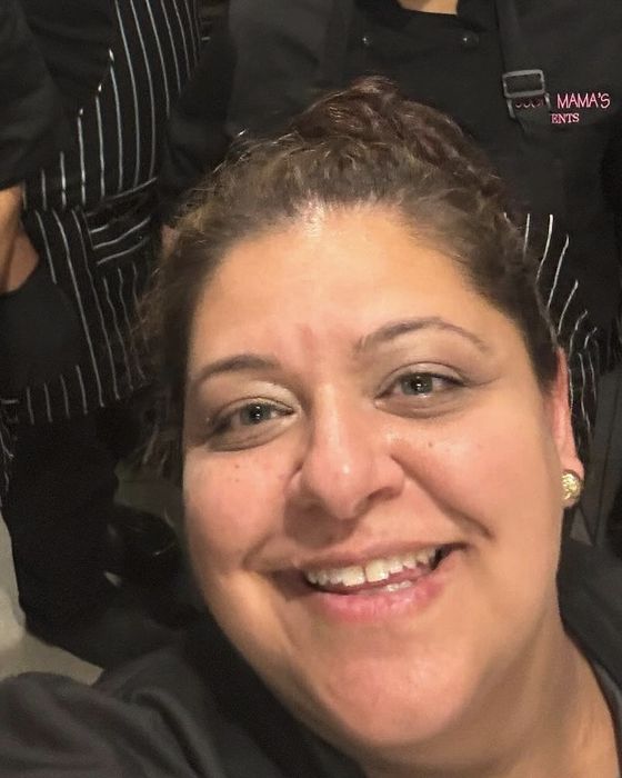 Chef Taisha smiling in front of her crew