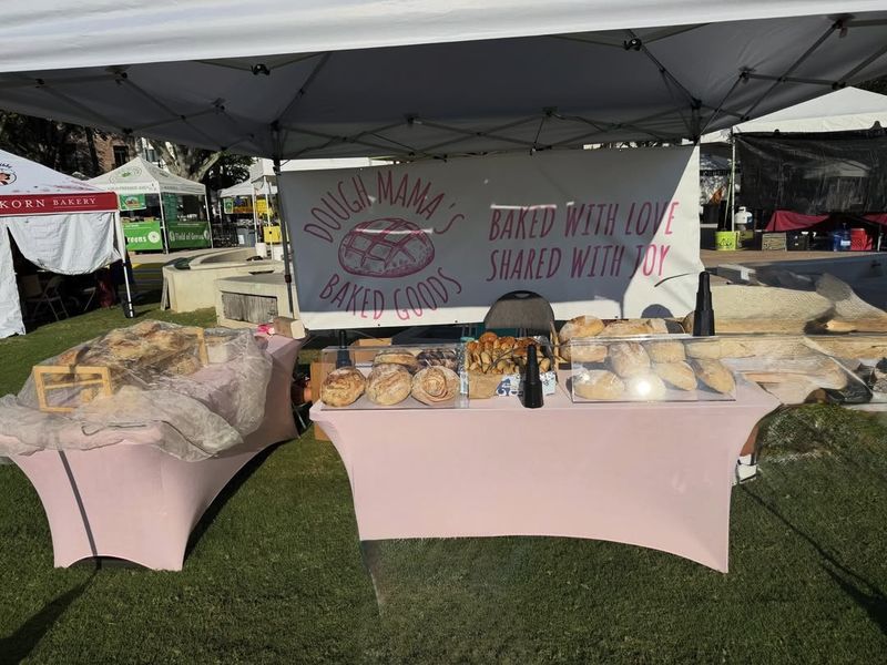 The Dough Mama’s market table dressed in pink with loaves, bagels and cookies