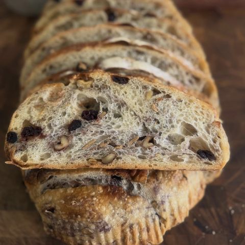 Cranberry walnut sourdough sliced thick, showing an open crumb