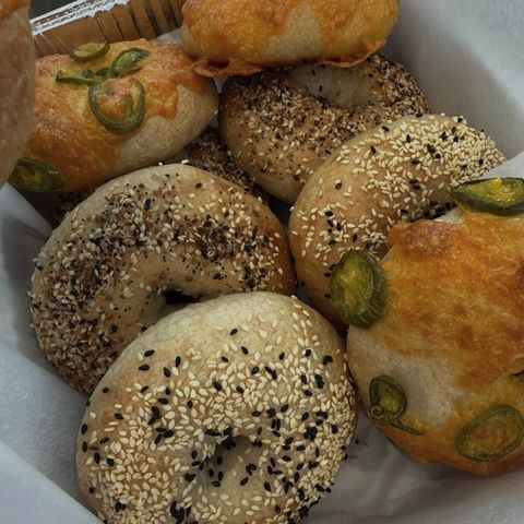 Jalapeño cheddar, everything and sesame bagels in a basket